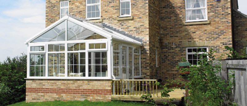 Glass conservatory roof on top of conservatory with brick base in Dorset