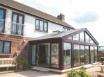 Icotherm tiled roof with window/skylight on top of glass conservatory