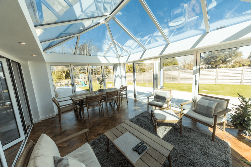 Glass conservatory roof on top of conservatory with bifold doors in Dorset